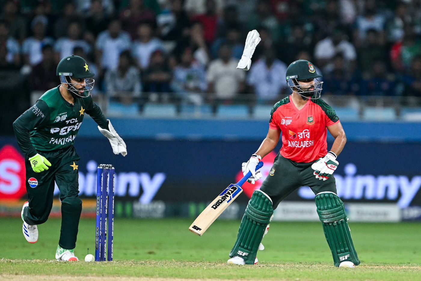 Mohammad Haris pops out his glove to gather the ball, wicketkeeper cricket pic
