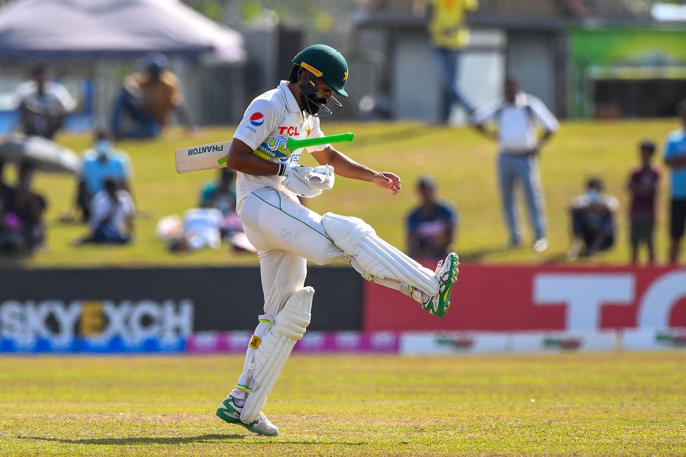 A frustrated Fawad Alam walks back after being dismissed
