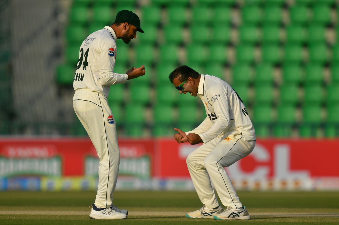 Shan Masood and Noman Ali celebrate the early wicket of Aiden Markram
