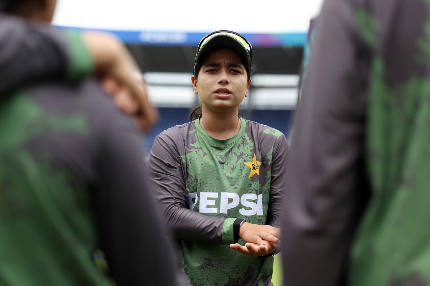 Fatima Sana talks to her team-mates during a huddle