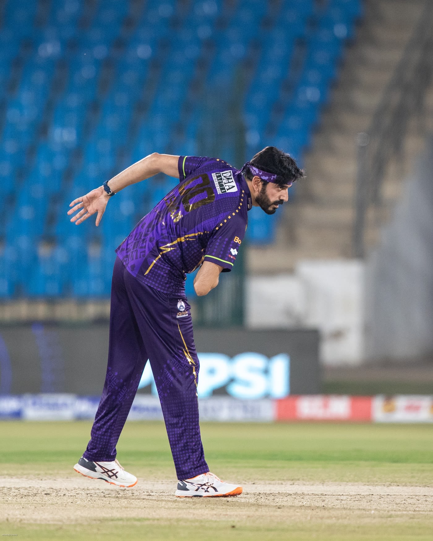 Usman Tariq takes a bow after taking a wicket